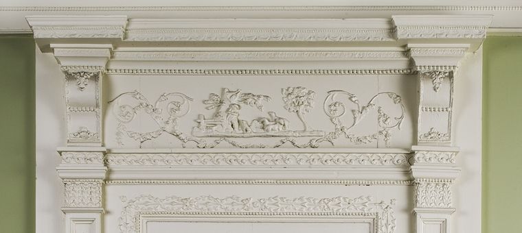 The detail on the overmantel in the Benkard Room at The Met is in neoclassical style.