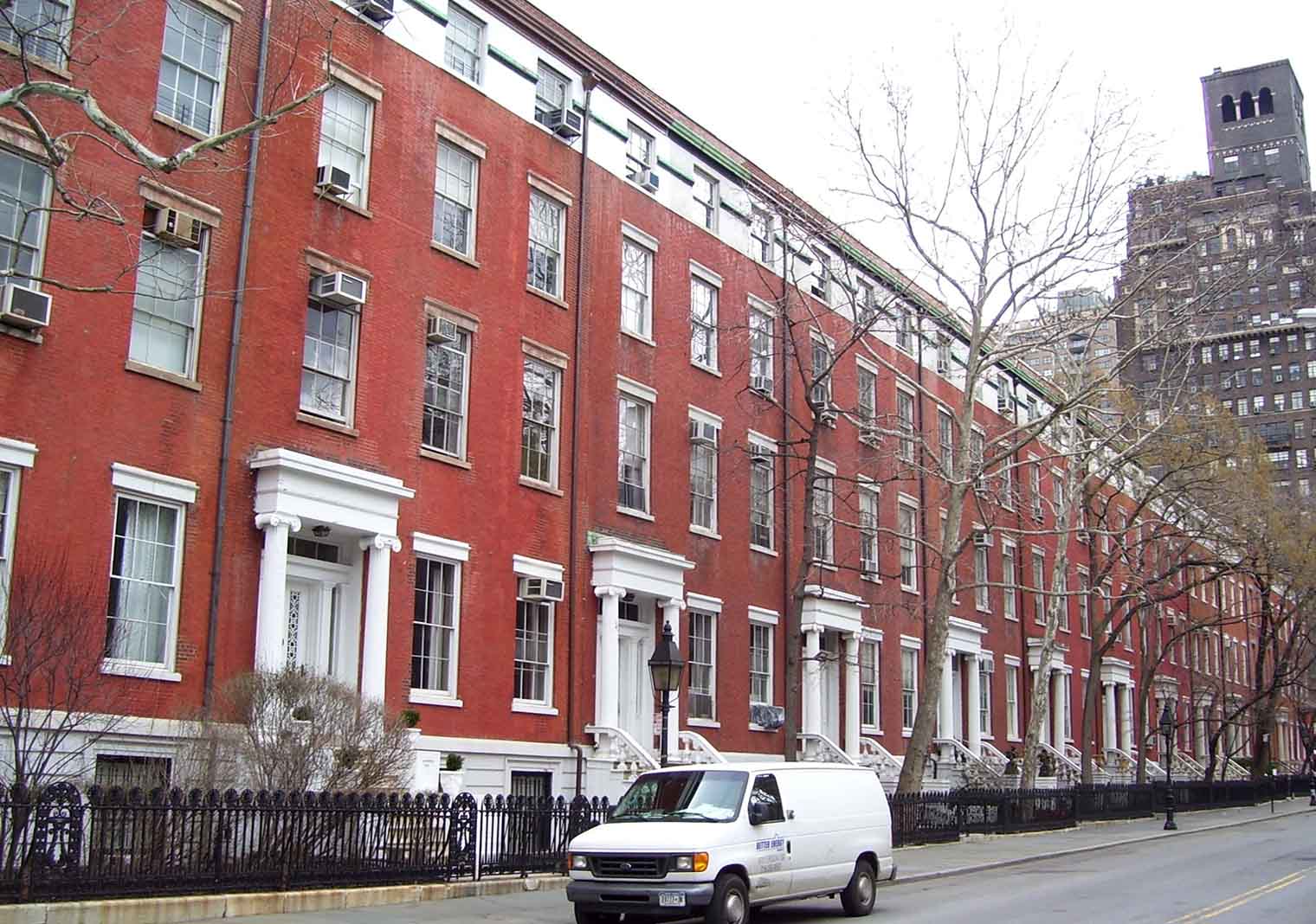 "The Row" of town houses at 1(right)-13(left) Washington Square North between Fifth Avenue and University Place in the Greenwich Village neighborhood of Manhattan, New York City, was built in 1832-33. Some of these (#7-13, nearest the camera) are only facades, having been gutted to make multiple-dwelling housing, with an entrance pergola facing Fifth Avenue. This is owned by New York University, and is sometimes referred to as "One-Half Fifth Avenue". Also #3 was given a new facade in 1884, designed by J.E. Terhune. "The Row" is part of the Greenwich Village Historic District. {Source: AIA Guide to NYC (4th ed.))