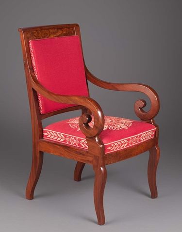 A wooden armchair with modern upholstery. 