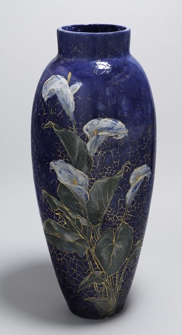 A blue painted and glossed earthenware vase with details of flowers