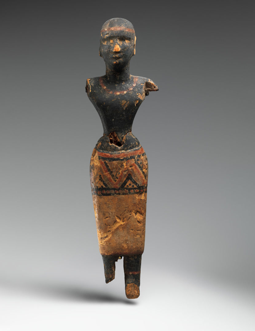Figure of a Woman of Nubian Descent. The figure is of a dark-skinned young woman who wears a brightly patterned skirt, a necklace, anklets, and a fillet around her head.