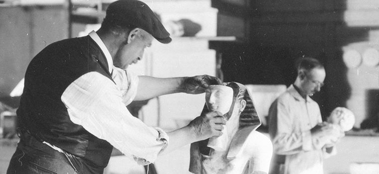 Archival image of art conservators working on Egyptian statues
