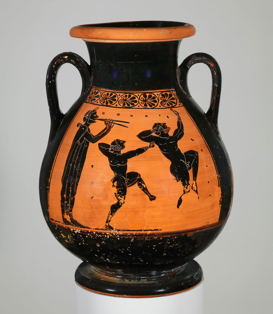 A terracotta vessel depicting two men shadowboxing while another plays the flute