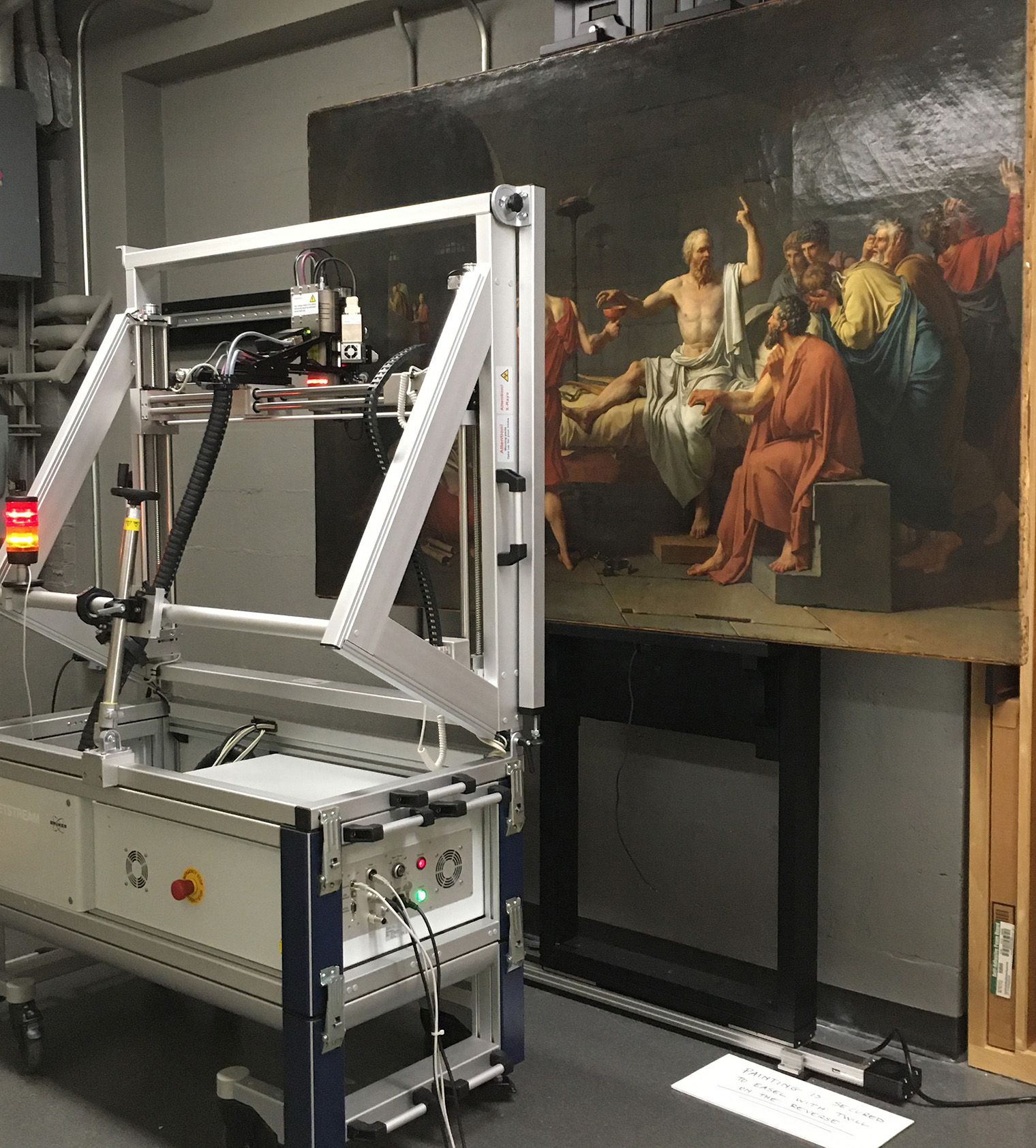 Photo showing The Death of Socrates painting being scanned