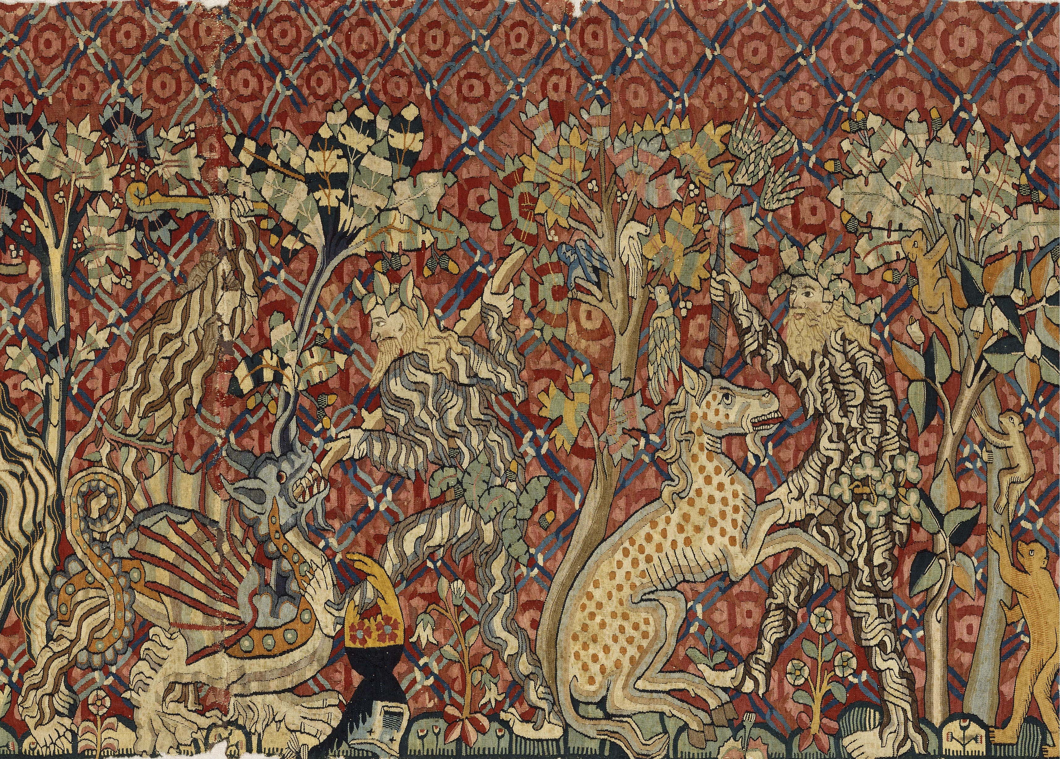Tapestry with wild men hunting a unicorn and a dragon