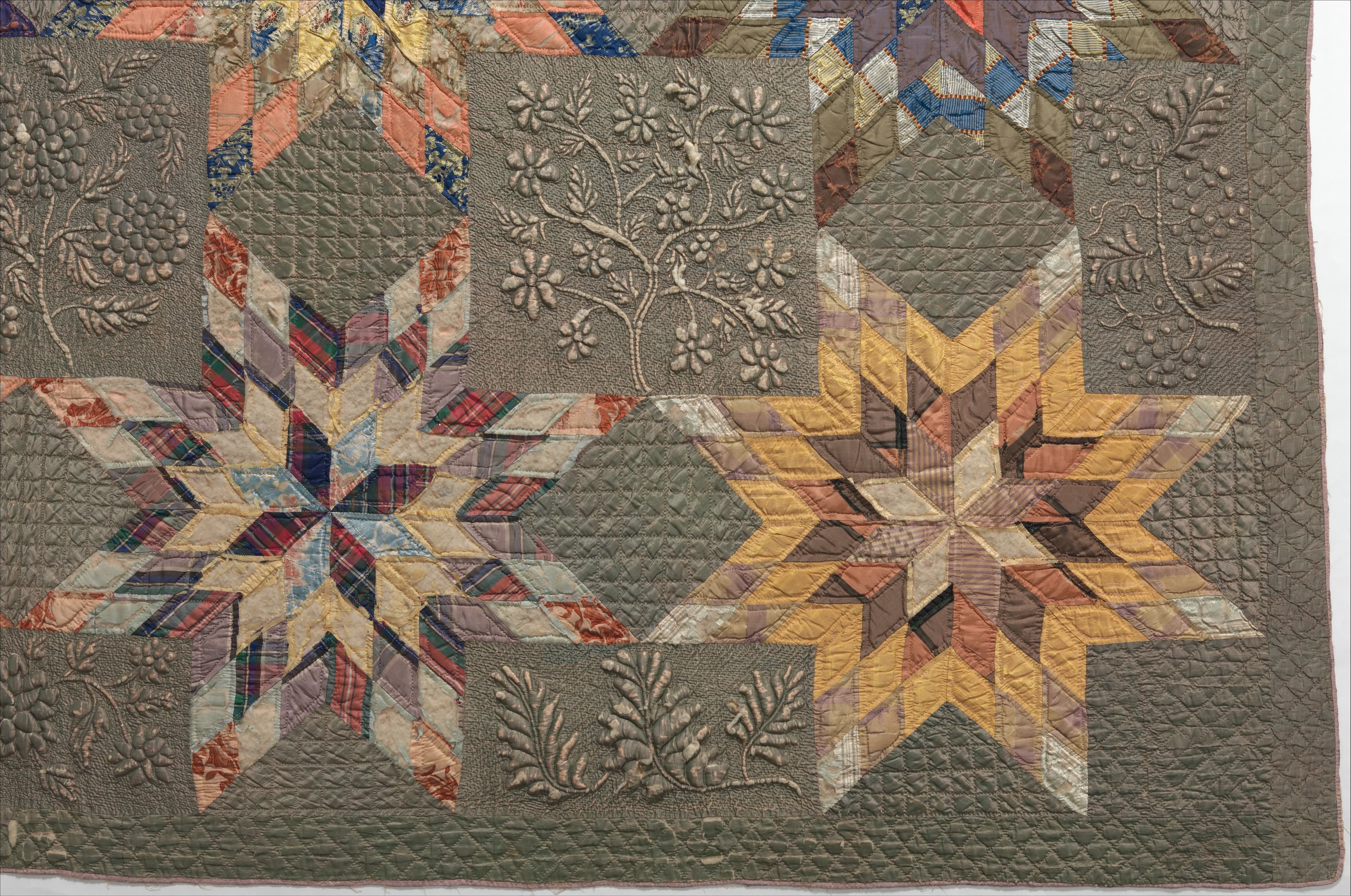 A detail of a silk and cotton quilt that features multicolored stars