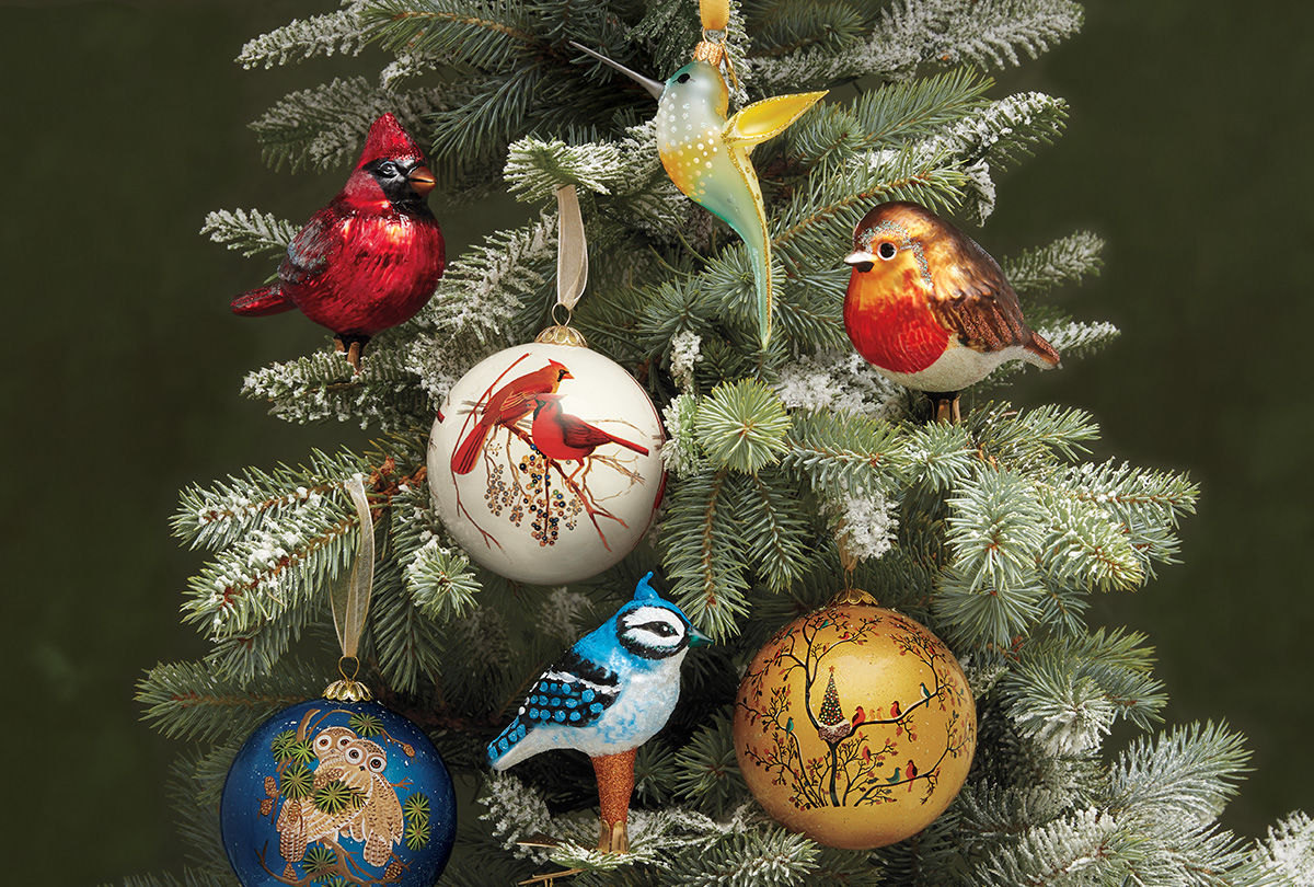 Bird themed ornaments decorate a Christmas tree.