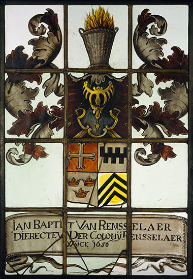 Stained-glass window featuring a family crest.