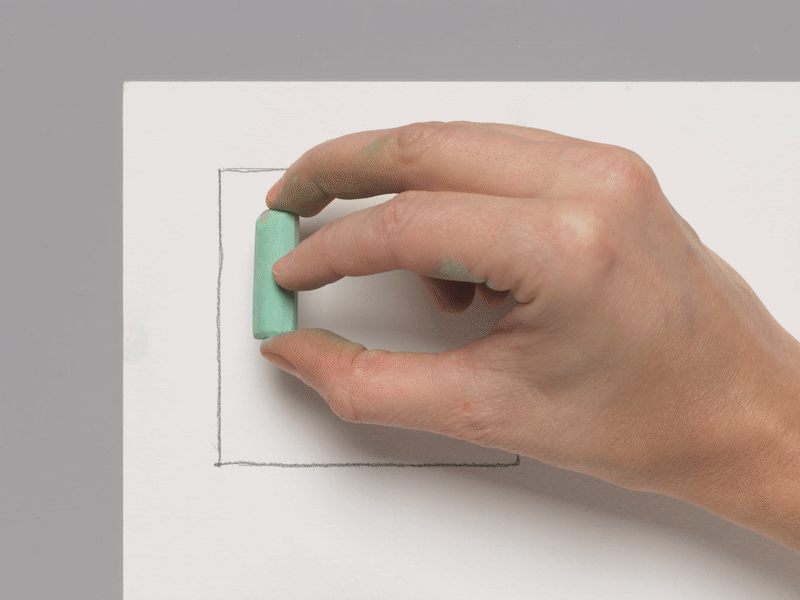 A moving image of a hand making broad and then thin marks with a green pastel pencil.