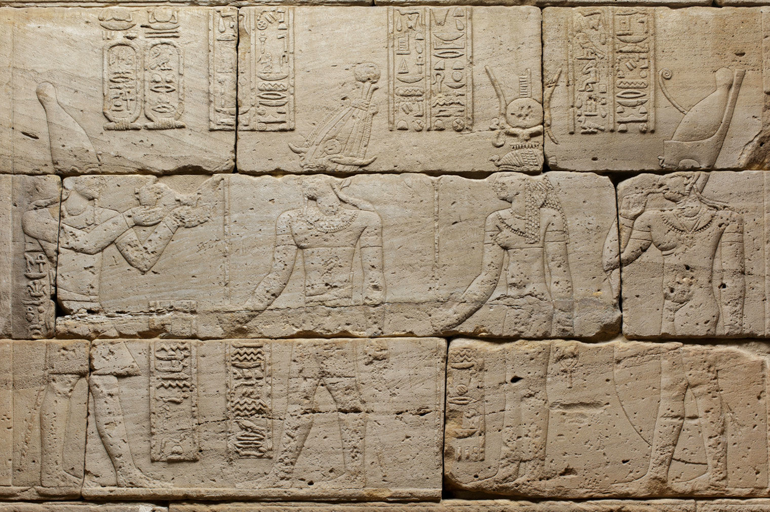 Detail depicting Augustus (left) offering milk to Osiris, Isis, and Harpocrates