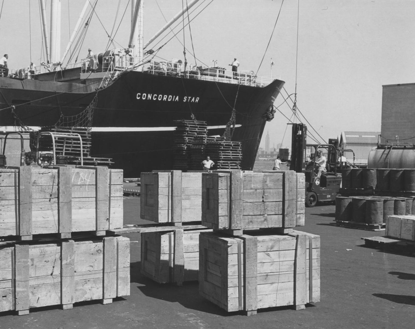 Archival photo of shipping crates stacked on a pier