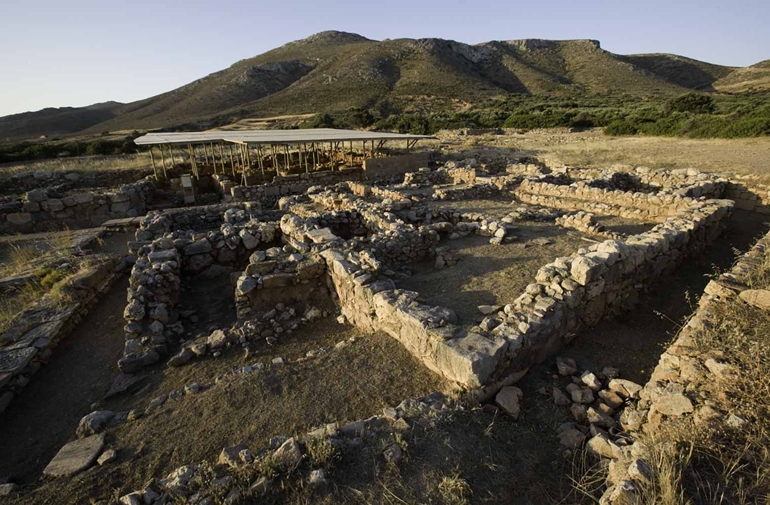Building 4 and Building 5 (with modern roof) of the 1986-2003 excavations at Palaikastro, Petsophas in the background