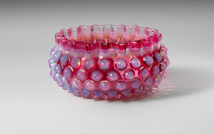 Hobnail finger bowl made from pressed cranberry and opalescent glass