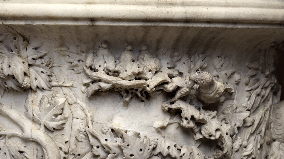 This detail, showing a mother bird feeding its young in the nest, is part of the original composition.