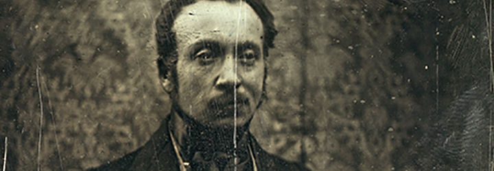 A daguerreotype of the artist, a middle-aged man with a dark moustache and receding hairline, posed upright and nobly.