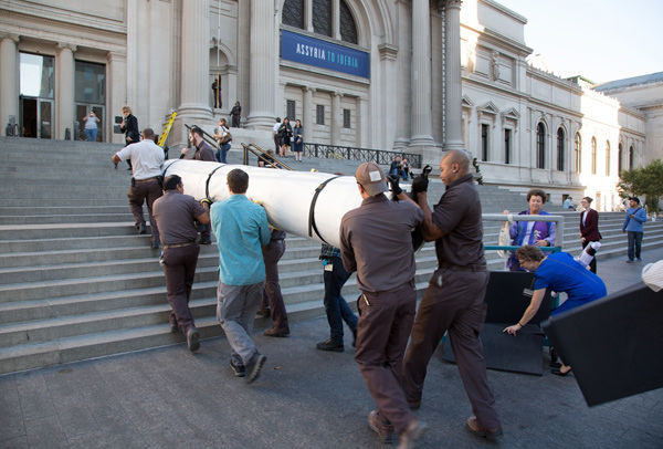 Carrying the tapestry up the Museum's front steps