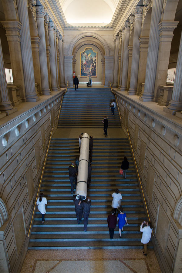 The tapestry is carried up the large staircase just inside the Museum's Great Hall