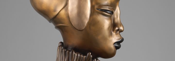 A detail of a bronze sculpture of a woman