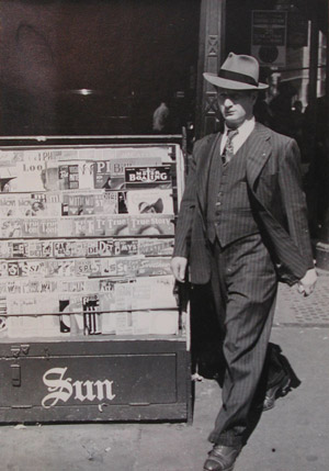 [Man in Pinstriped Suit and Magazine Rack, New York City]