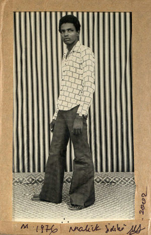 Untitled [Portrait of a Man Standing Before a Striped Background]