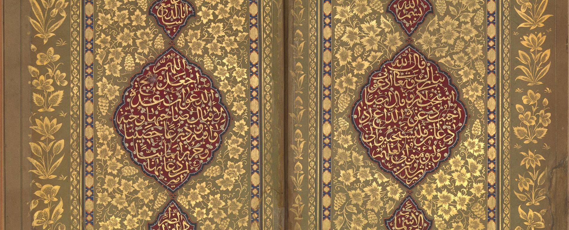Detail of an Islamic Book of Brayers with gold illustrations of flowers surrounding a crimson design containing Arabic text