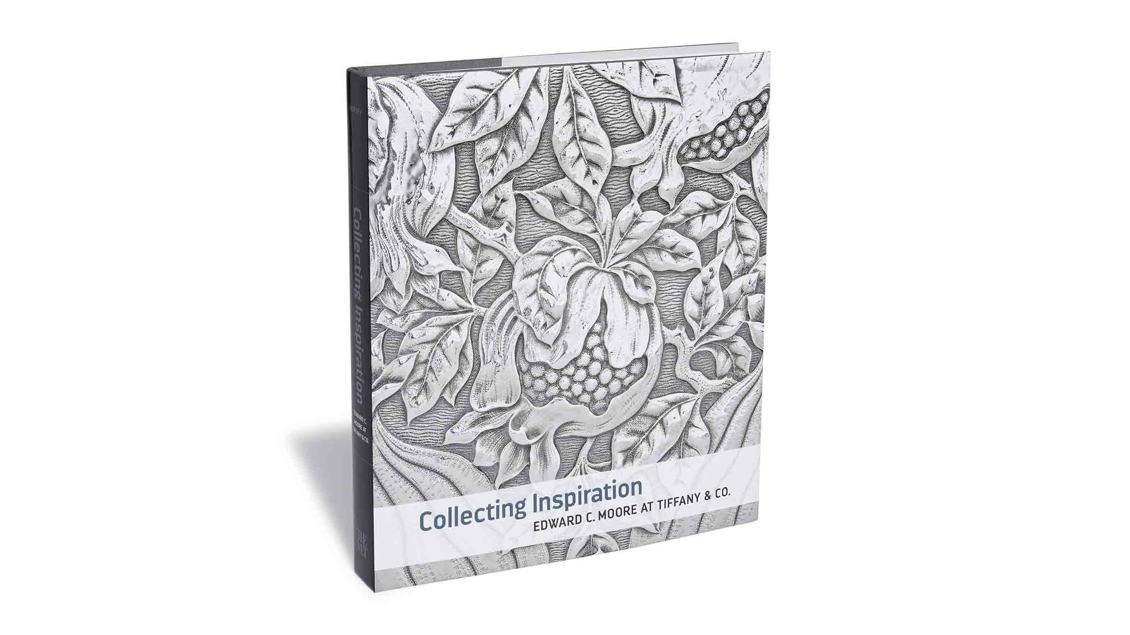 The cover of Collecting Inspiration: Edward C. Moore at Tiffany & Co. A detail of floral embellishments engraved in silver on an object from the Edward C. Moore collection is depicted on the cover.