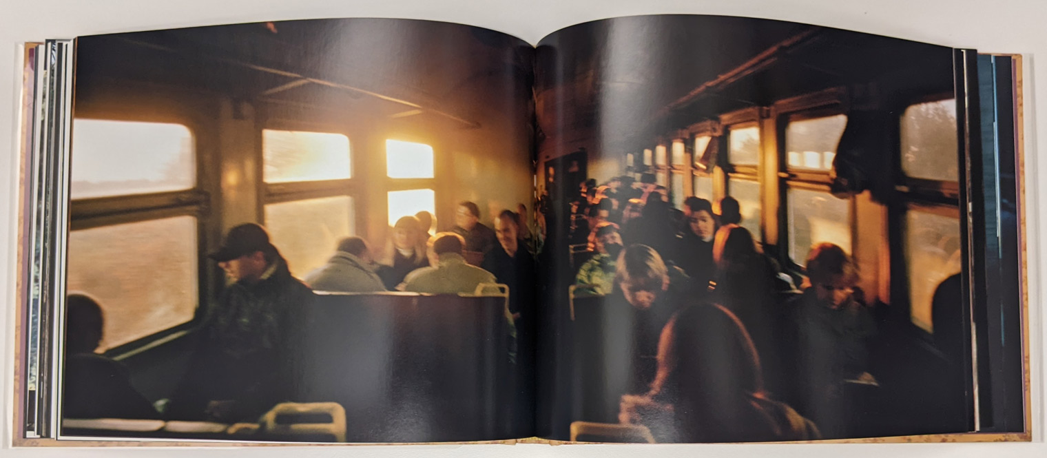 Photograph of the inside of a commuter train filled with people