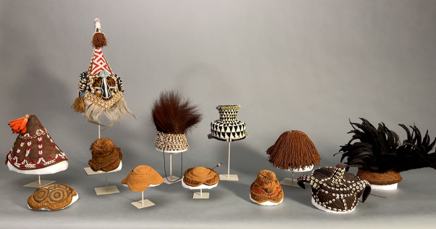 Hats designed by Lilly Daché on a gray background