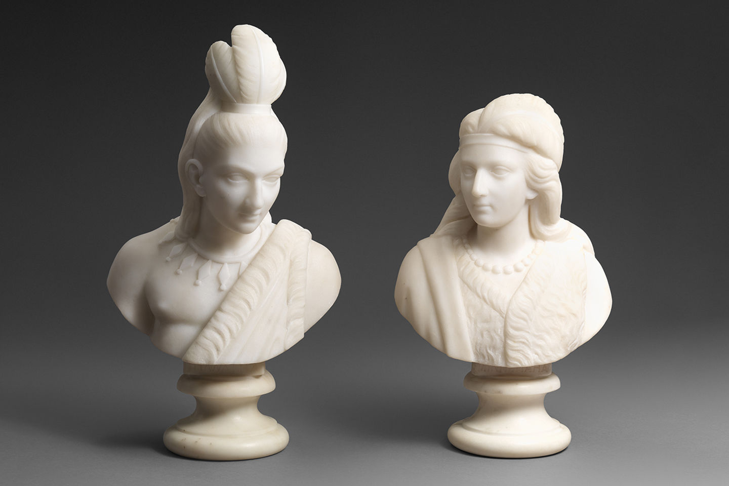 Two marble busts of Native American figures, Minnehaha and Hiawatha.