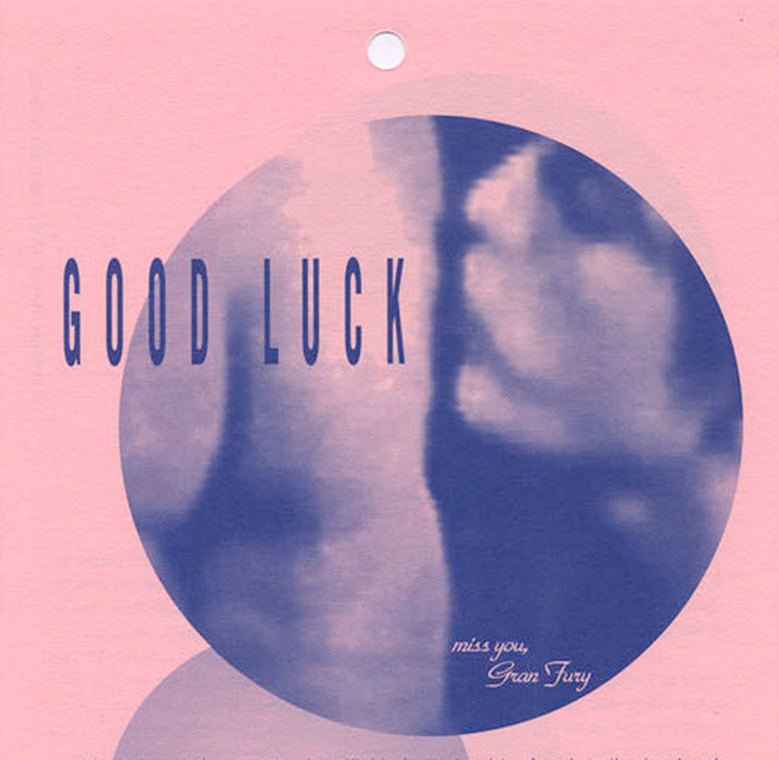 Blurred, circular image in blue ink showing a person kissing a butt. Text reads "Good Luck [...] miss you, Gran Fury"