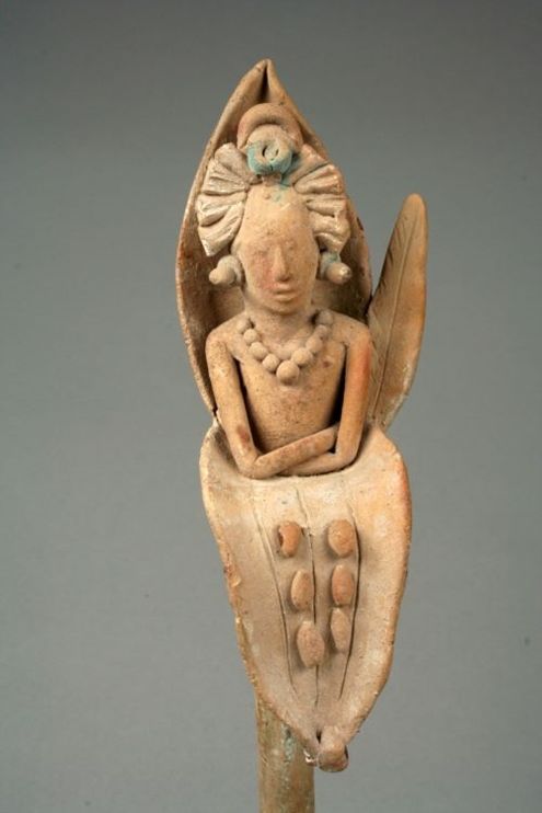 Sculpture of Mayan corn god emerging from flower made of clay and pigment