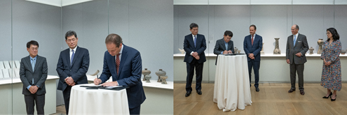 On the left, a group of men in suits sign a piece of paper. On the right, a group of men and a woman watch as one sign a piece of paper.